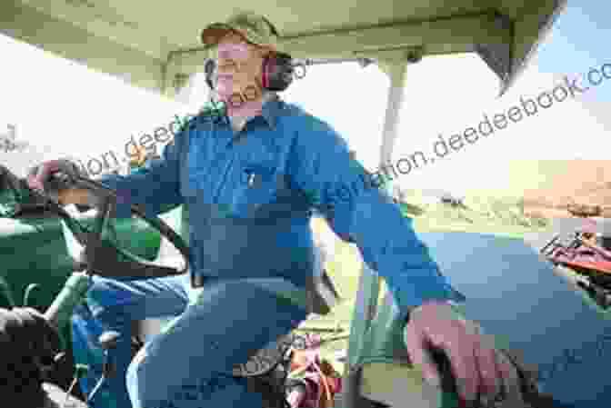 A Farmer Sits Inside The Enclosed Cab Of A Tractor, Wearing Earplugs For Additional Noise Protection A Very Very Noisy Tractor